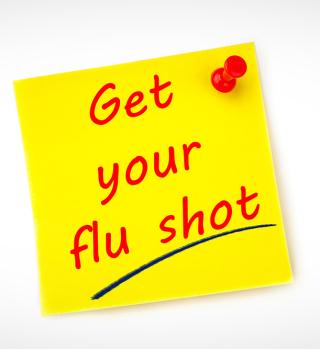 A sticky note that says "Get your flu shot"