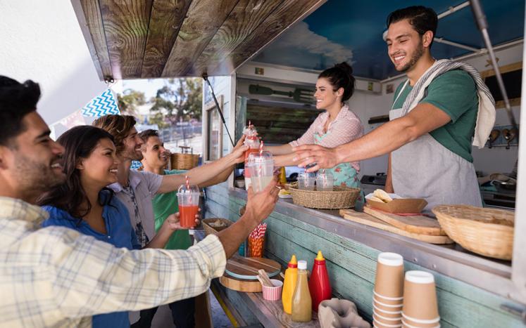 Picture of people receiving food from a food truck vendor.